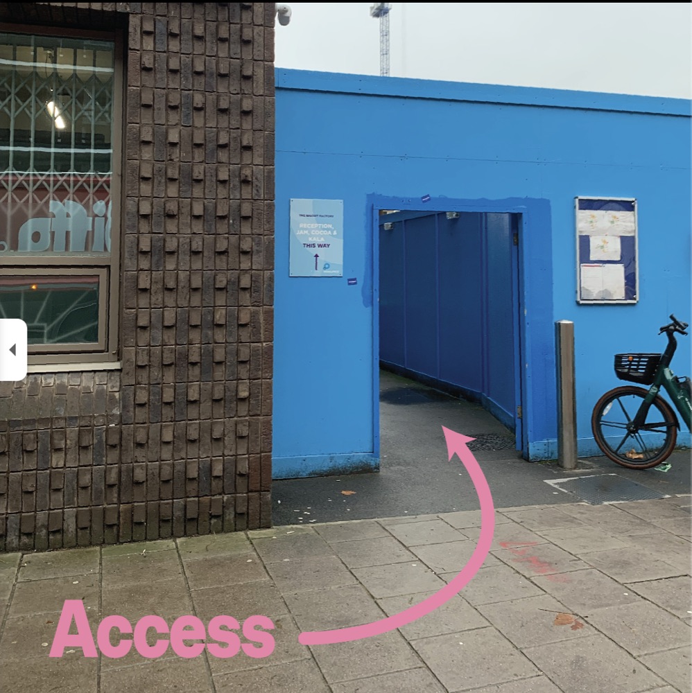 Photo of the blue hoarding entrance walkway leading to Cocoa Studios
